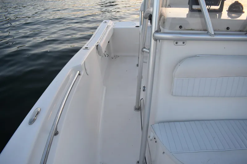 Slide: The Image of 2007 Tidewater 216 CC Adventure boat interior with seating and railing by the water. - 13
