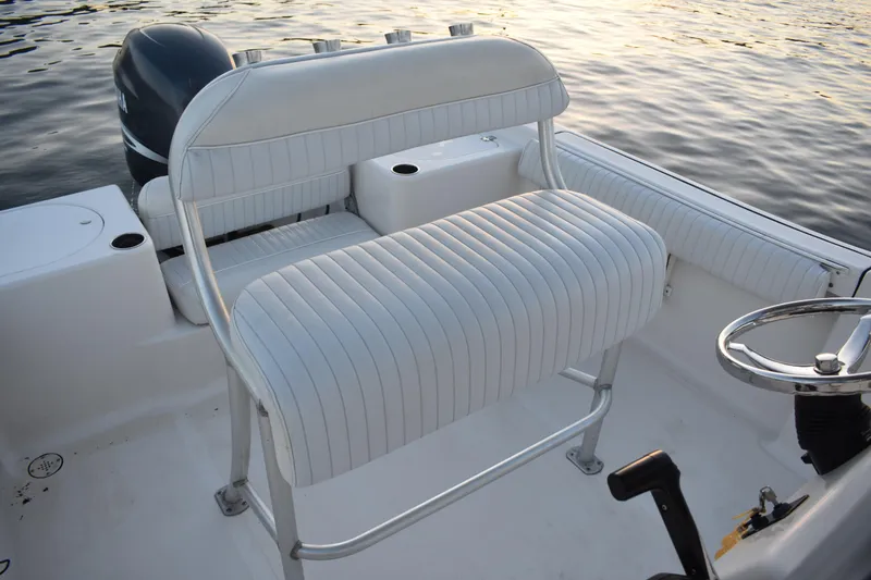 Slide: The Image of 2007 Tidewater 216 CC Adventure boat interior with white seating and steering wheel. - 16
