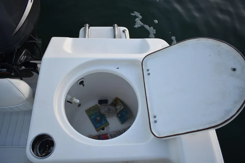 Slide: The Image of Open storage compartment on 2007 Tidewater 216 CC Adventure boat with items inside. - 23