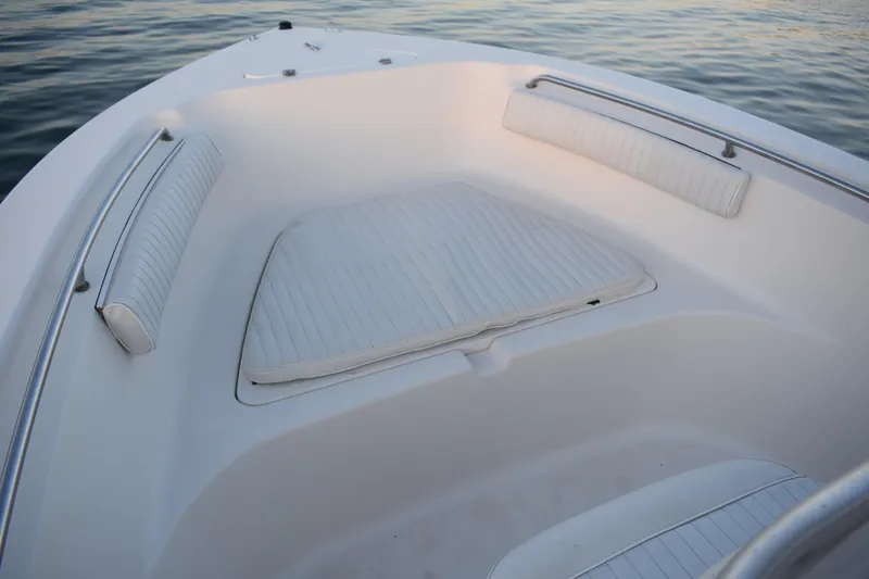 Slide: The Image of 2007 Tidewater 216 CC Adventure boat interior with cushioned seating and railings. - 5