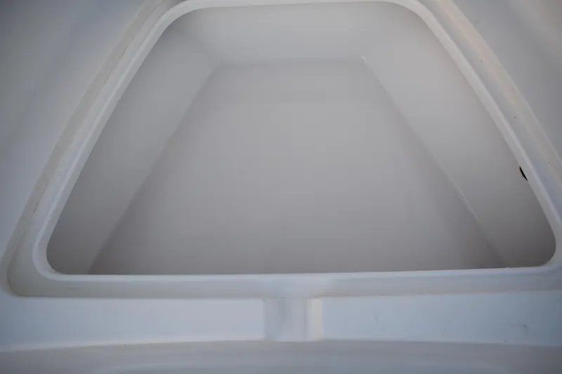 Slide: The Image of Storage compartment of a 2007 Tidewater 216 CC Adventure boat, featuring a clean, white interior. - 8