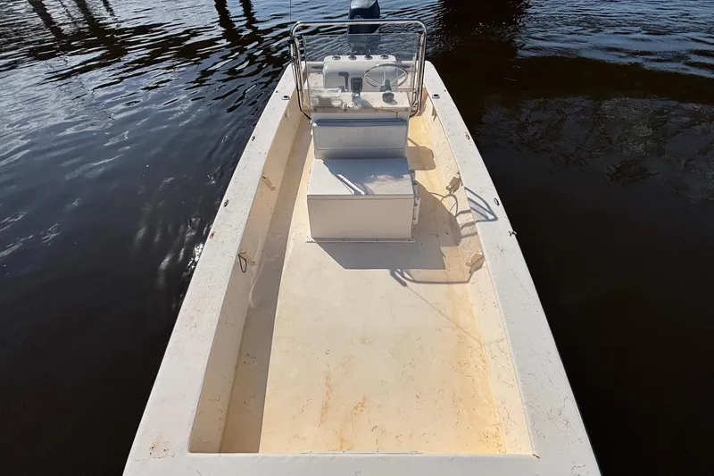 Slide: The Image of 2005 Jones Brothers Bateau 20 boat on calm water, featuring a center console. - 10