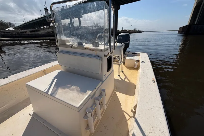 Slide: The Image of 2005 Jones Brothers Bateau 20 boat docked near a bridge on a sunny day. - 11