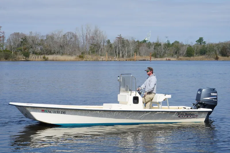 Slide: The Image of Man piloting 2005 Jones Brothers Bateau 20 boat on calm lake. - 3