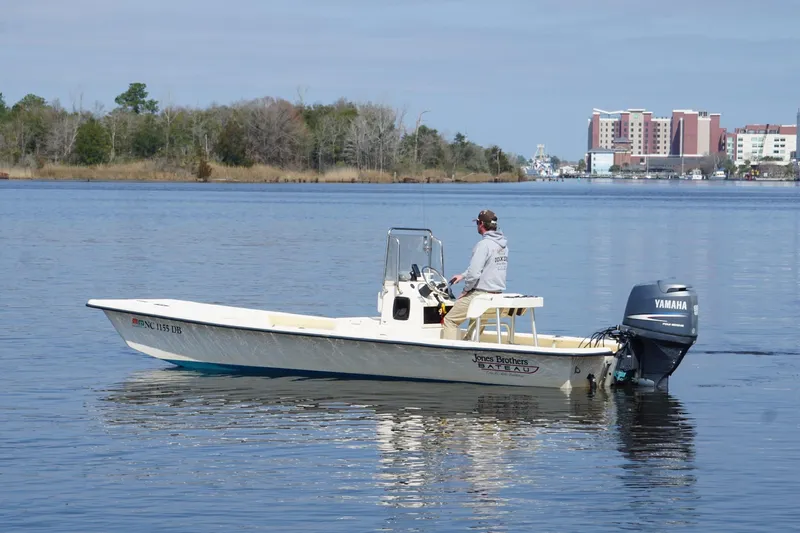 Slide: The Image of 2005 Jones Brothers Bateau 20 boat on calm water with Yamaha outboard motor. - 4