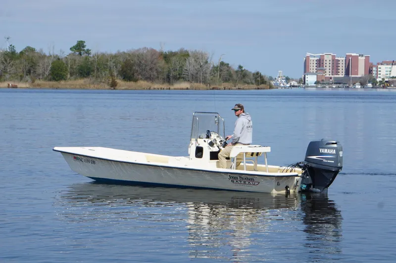 Slide: The Image of 2005 Jones Brothers Bateau 20 boat on calm water with Yamaha outboard motor. - 6