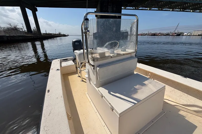 Slide: The Image of Jones Brothers Bateau 20 boat, 2005 model, under a bridge on calm water. - 8