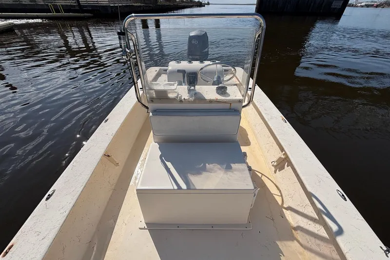 Slide: The Image of 2005 Jones Brothers Bateau 20 boat on calm water, featuring a central console. - 9