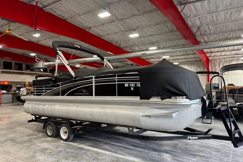 Slide: The Image of 2010 Bennington 2250 RCW pontoon boat on trailer in indoor storage facility. - 13