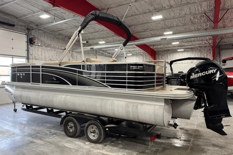 Slide: The Image of 2010 Bennington 2250 RCW pontoon boat with Mercury engine in indoor storage. - 3