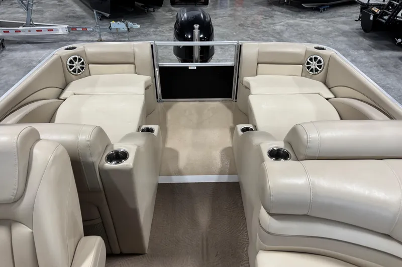 Slide: The Image of Interior of a 2010 Bennington 2250 RCW pontoon boat with beige seating and cup holders. - 8