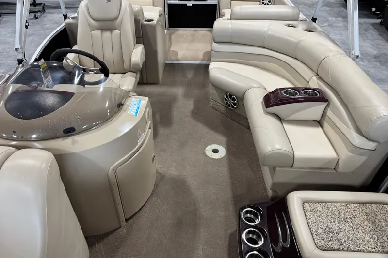 Slide: The Image of Interior of a 2010 Bennington 2250 RCW pontoon boat with beige seating and cup holders. - 9