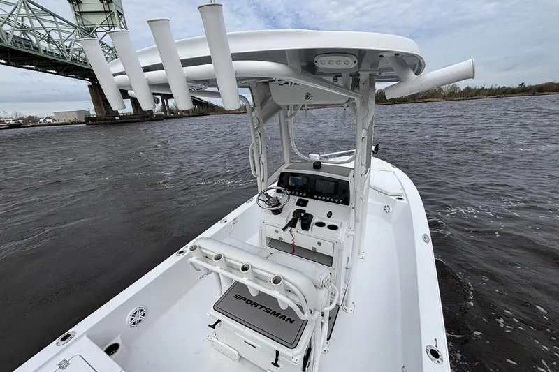 Slide: The Image of 2021 Sportsman Tournament 234 Bay Boat on water near a bridge, showcasing helm and seating. - 11