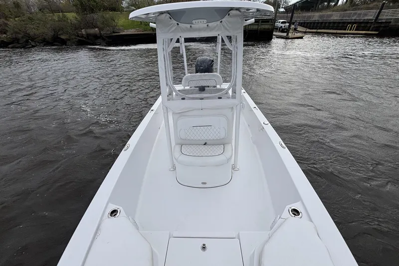 Slide: The Image of 2021 Sportsman Tournament 234 Bay Boat on water, showcasing sleek design and spacious deck. - 9