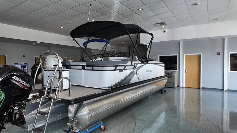 Slide: The Image of 2025 Avalon LSZ pontoon boat in showroom with Mercury engine. - 19