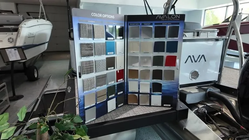 Slide: The Image of Avalon LSZ 2025 boat color options displayed in showroom. - 23