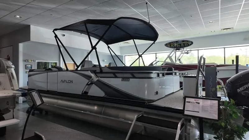 Slide: The Image of 2025 Avalon LSZ pontoon boat in showroom with canopy. - 4