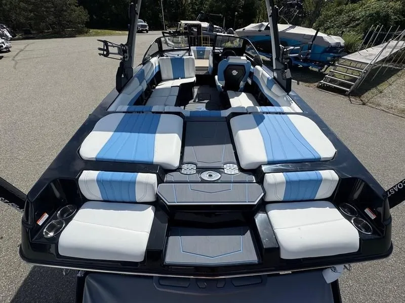 Slide: The Image of 2026 Malibu Wakesetter 22 LSV with blue and white seating outdoors. - 13