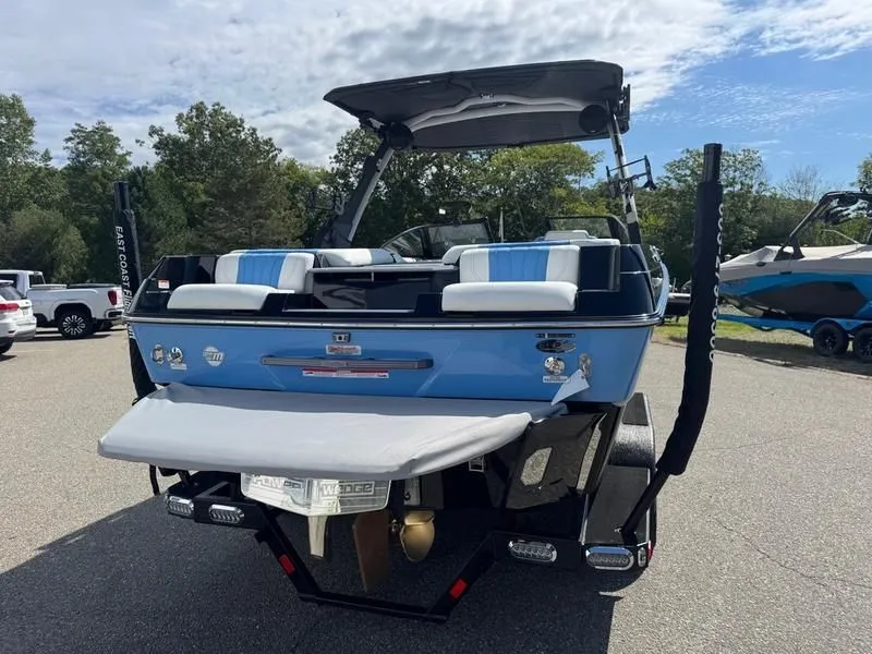 Slide: The Image of 2026 Malibu Wakesetter 22 LSV boat, blue, parked outdoors. - 8