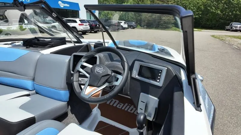 Slide: The Image of Interior of 2025 Malibu TXi featuring modern steering wheel and dashboard. - 10