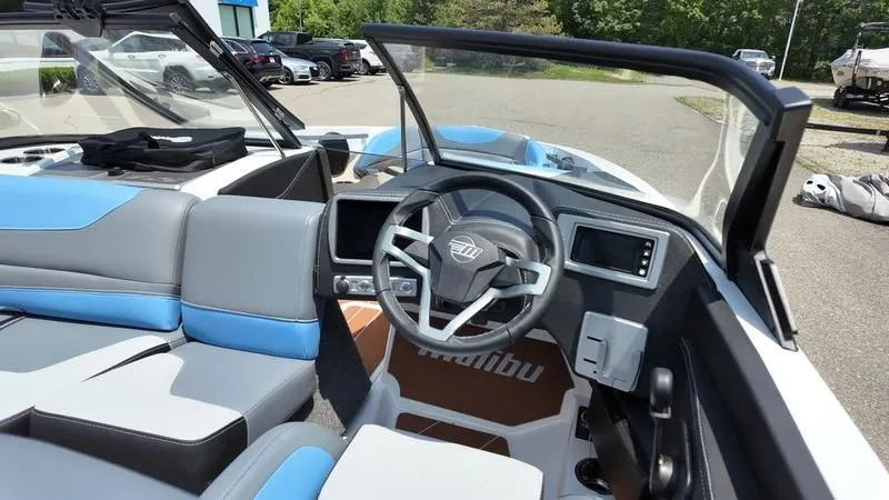 Slide: The Image of Interior of 2025 Malibu TXi with modern steering wheel and blue seats. - 16