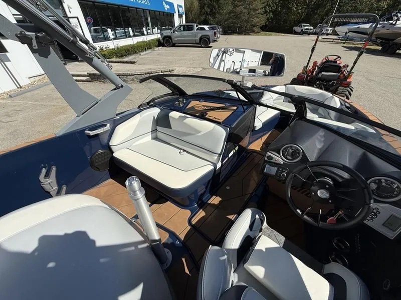 Slide: The Image of Interior of a 2024 Malibu TXi boat with modern seating and controls. - 11