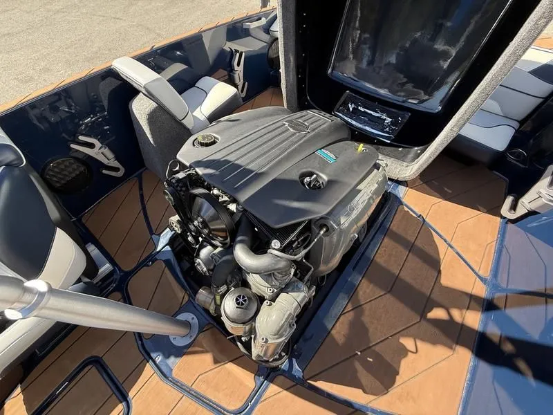 Slide: The Image of 2024 Malibu TXi boat interior with open engine compartment. - 12