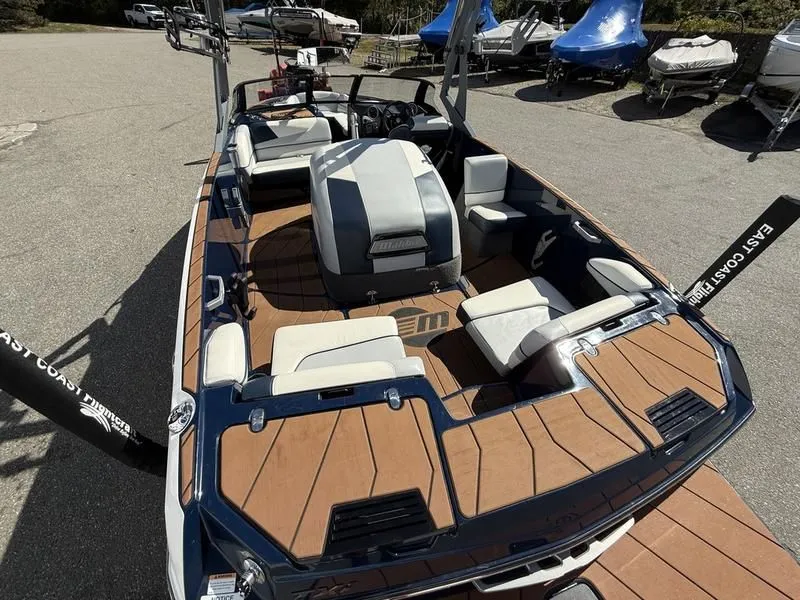 Slide: The Image of 2024 Malibu TXi boat with luxurious interior and wood flooring. - 13