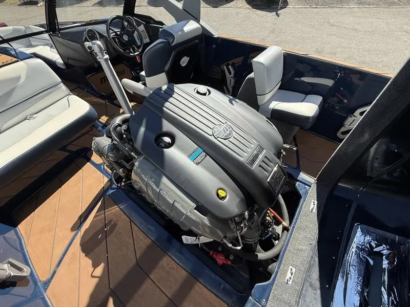 Slide: The Image of Engine compartment of 2024 Malibu TXi boat with exposed engine. - 14