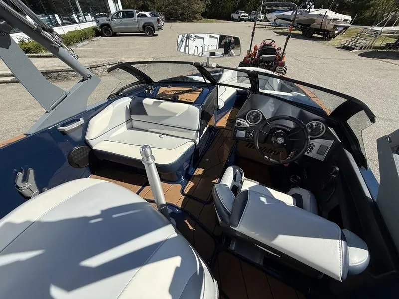 Slide: The Image of Interior of 2024 Malibu TXi boat with modern seating and controls. - 15