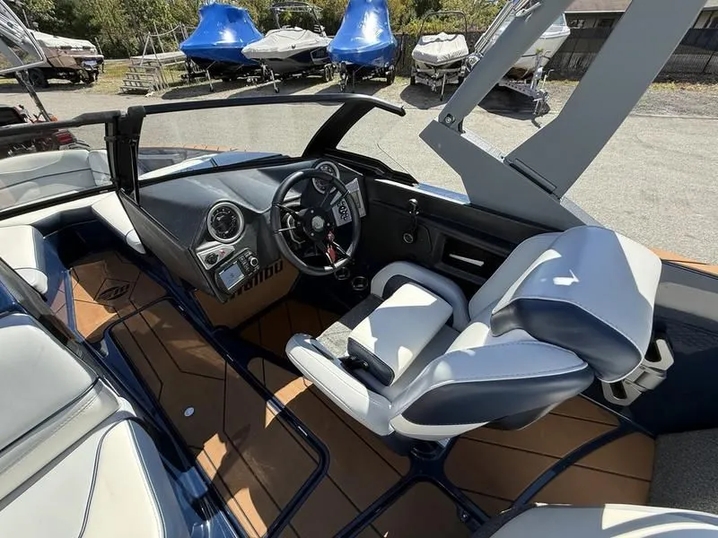 Slide: The Image of Interior of a 2024 Malibu TXi boat with modern cockpit. - 19