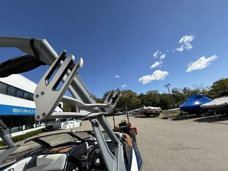 Slide: The Image of 2024 Malibu TXi boat with blue sky background. - 25