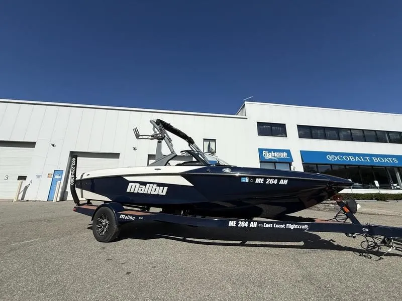 Slide: The Image of 2024 Malibu TXi boat parked in front of a building. - 3