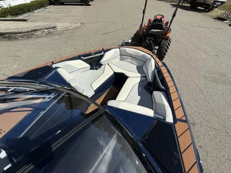 Slide: The Image of 2024 Malibu TXi boat with luxurious interior and trailer. - 6