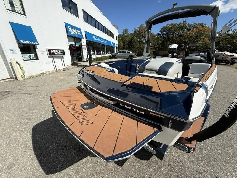Slide: The Image of 2024 Malibu TXi boat at East Coast Flightcraft dealership. - 7
