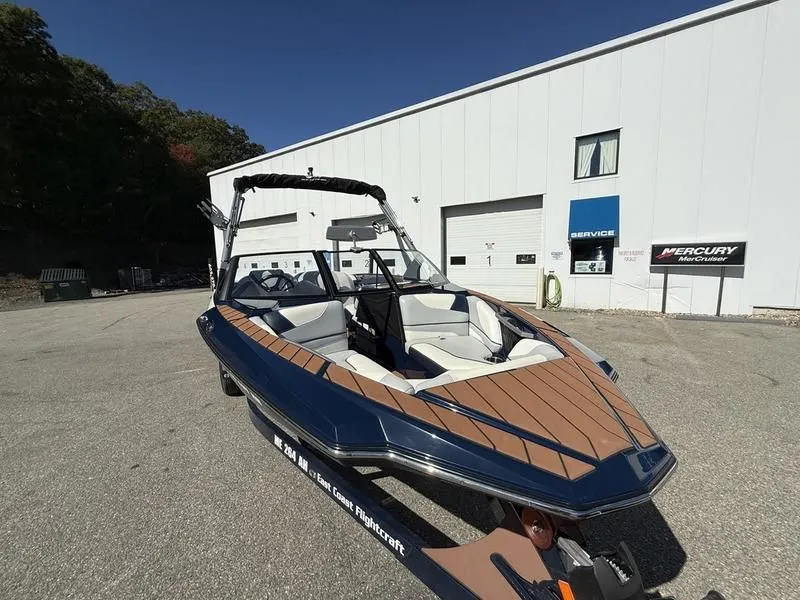 Slide: The Image of 2024 Malibu TXi boat parked in front of a building. - 8