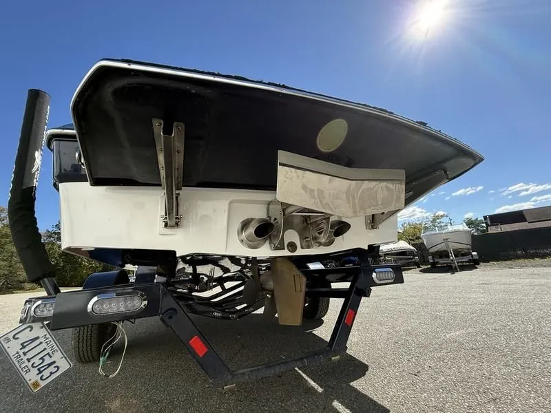 Slide: The Image of Rear view of a 2024 Malibu TXi boat on a trailer. - 9