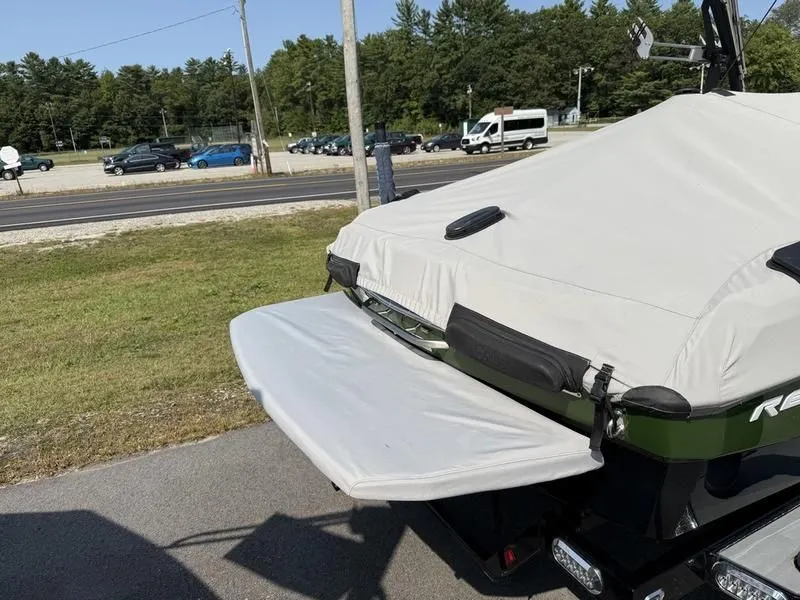 Slide: The Image of Covered 2022 Malibu TXi boat parked outdoors. - 16