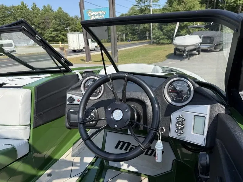 Slide: The Image of Interior view of 2022 Malibu TXi boat with dashboard and steering wheel. - 17