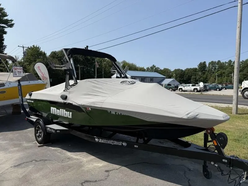 Slide: The Image of 2022 Malibu TXi boat with cover on trailer. - 21