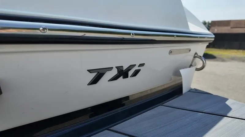 Slide: The Image of Close-up of the 2025 Malibu TXi boat model. - 13