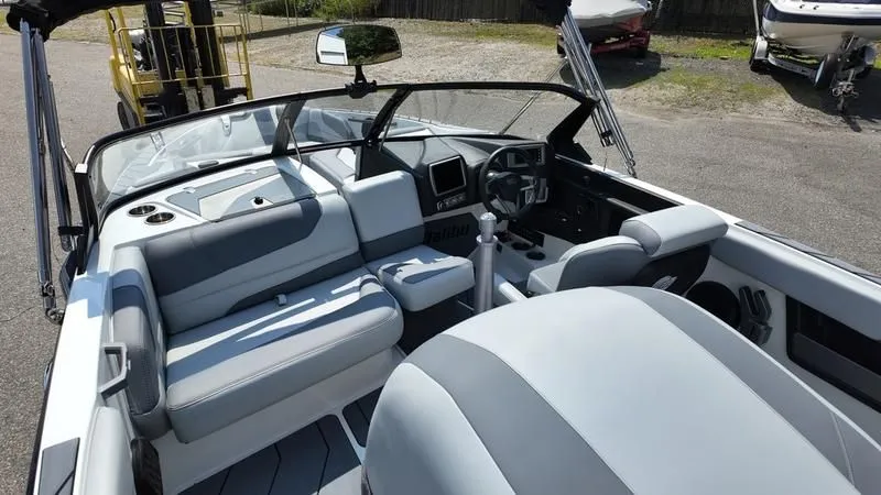 Slide: The Image of Interior of a 2025 Malibu TXi boat with gray seating. - 22