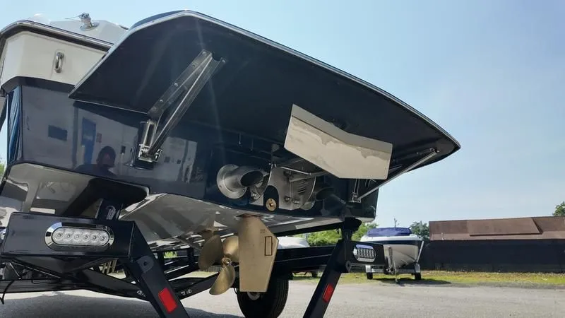 Slide: The Image of Rear view of the 2025 Malibu TXi boat on a trailer. - 27