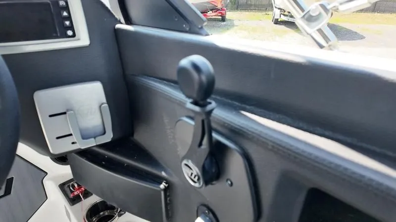 Slide: The Image of Interior view of 2025 Malibu TXi boat cockpit with control lever. - 28
