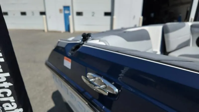 Slide: The Image of Close-up of a 2025 Malibu TXi boat outdoors. - 32