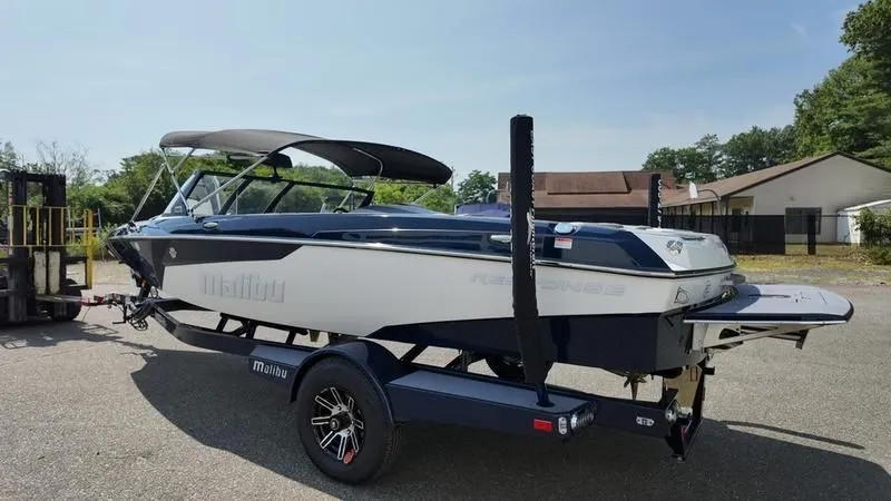 Slide: The Image of 2025 Malibu TXi boat on trailer, side view. - 5