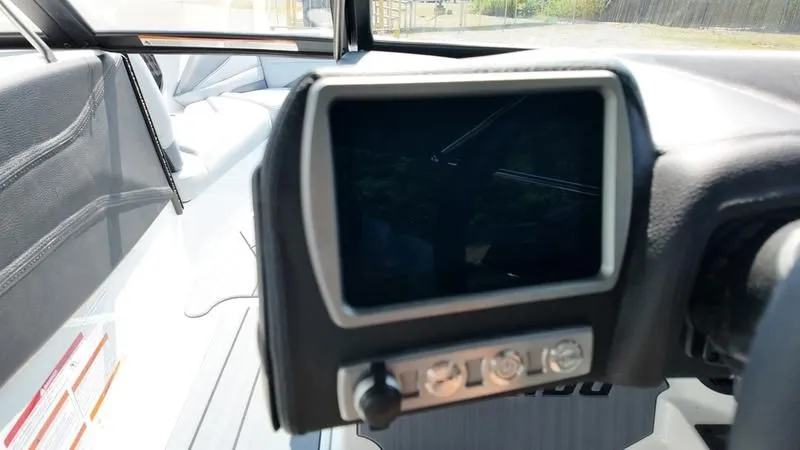 Slide: The Image of 2025 Malibu TXi boat featuring modern dashboard display. - 9