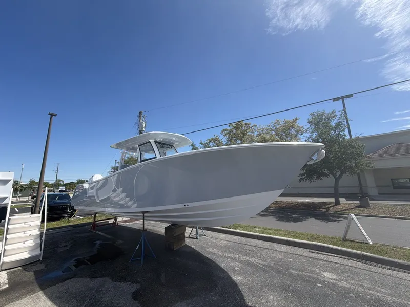 Slide: The Image of 2026 Sportsman Open 322 Center Console boat on a parking lot. - 10