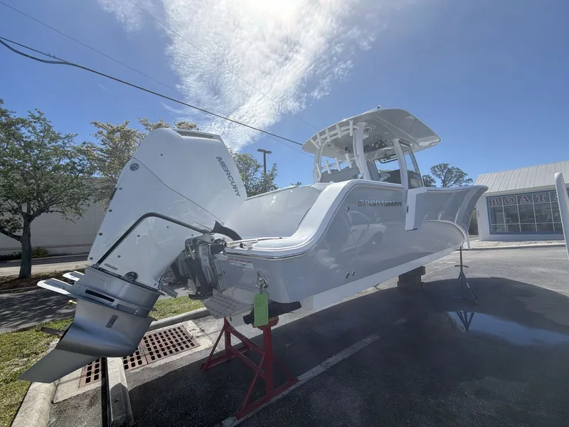 Slide: The Image of 2026 Sportsman Open 322 Center Console boat on stands outdoors. - 14
