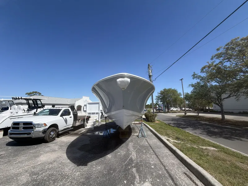 Slide: The Image of 2026 Sportsman Open 322 Center Console boat on parking lot. - 2